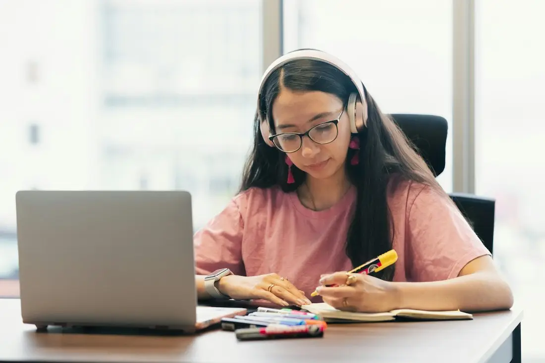 Una opositora estudiando con su portátil y subrayando apuntes
